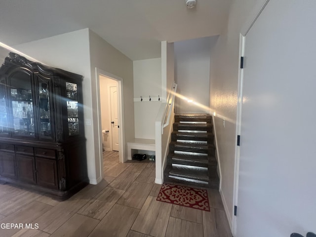 staircase with hardwood / wood-style floors