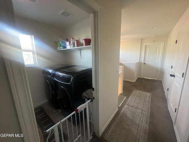 laundry area with washing machine and dryer and dark colored carpet