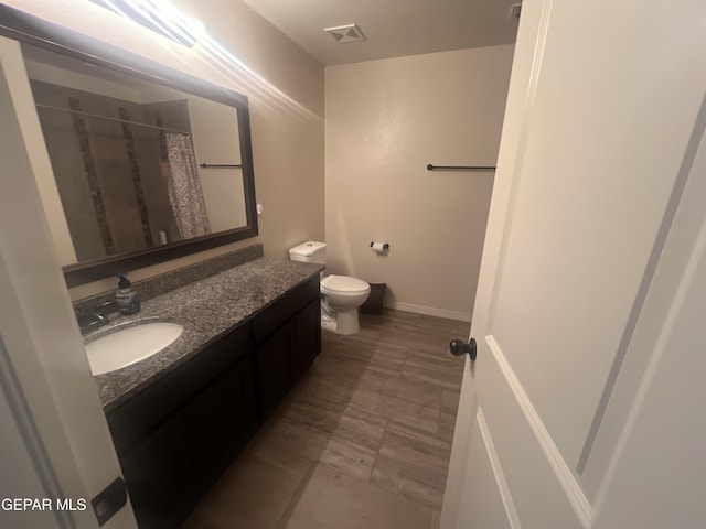 bathroom featuring oversized vanity and toilet