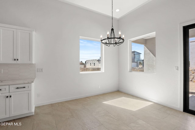 unfurnished dining area with a chandelier and light tile patterned floors