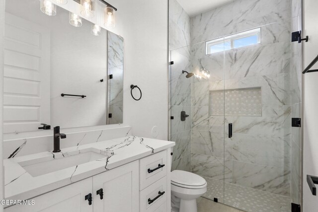 bathroom featuring walk in shower, vanity, and toilet