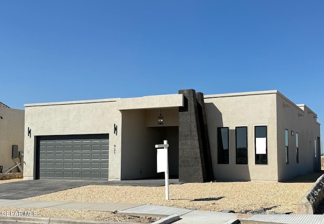 pueblo-style home featuring a garage