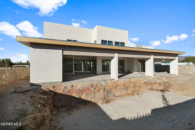 back of property featuring stucco siding and a patio