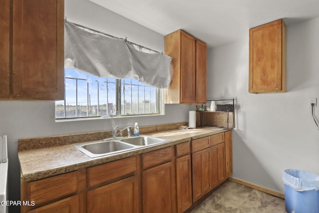 kitchen with sink and light tile floors