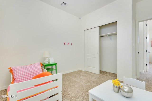 bedroom featuring carpet and a closet