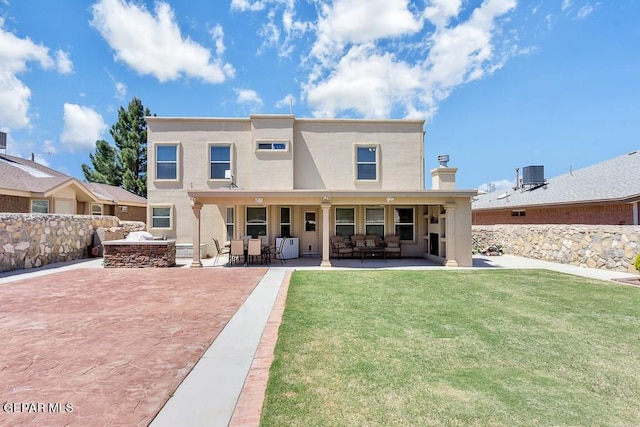 rear view of house with a patio area, a yard, and central AC