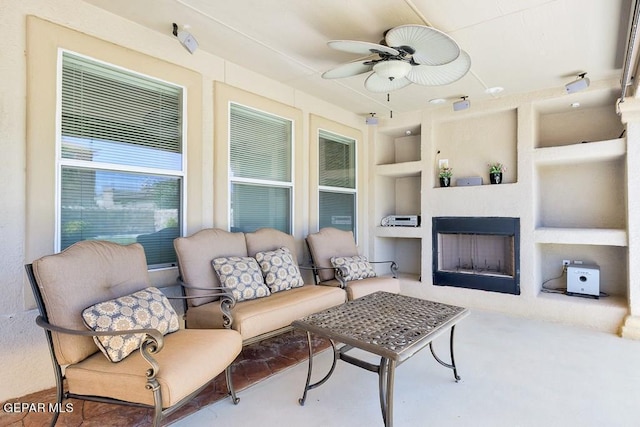 living room featuring built in features and ceiling fan