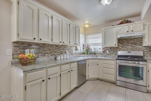 kitchen with white cabinets, stainless steel appliances, and tasteful backsplash