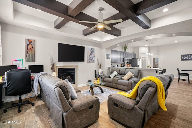 living room with beam ceiling, ceiling fan, and coffered ceiling