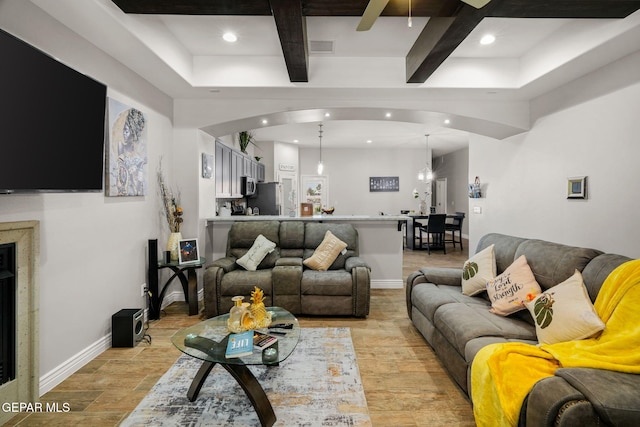 living room with beam ceiling and an inviting chandelier