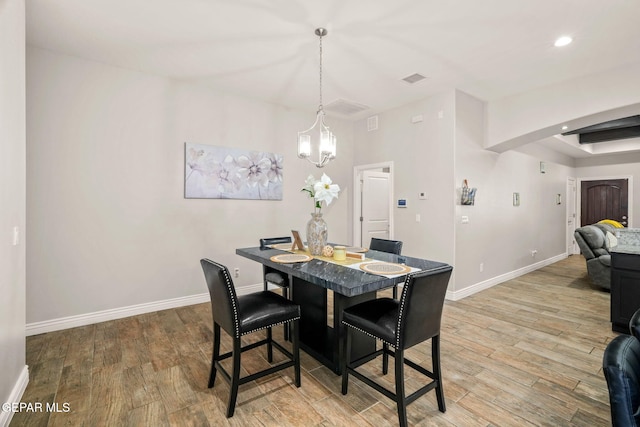 dining space with an inviting chandelier