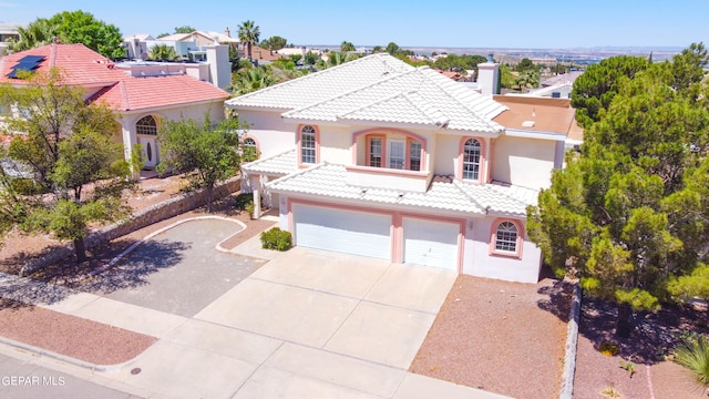 mediterranean / spanish-style home with a garage