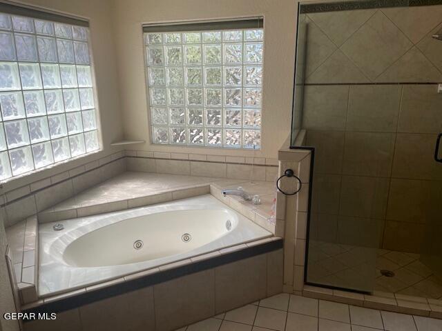 bathroom featuring tile patterned floors and independent shower and bath