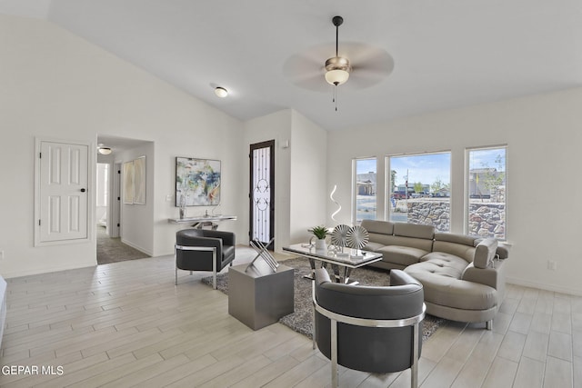 living room featuring ceiling fan, light hardwood / wood-style flooring, and high vaulted ceiling