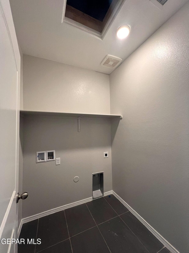 laundry area with gas dryer hookup, washer hookup, dark tile patterned flooring, and hookup for an electric dryer