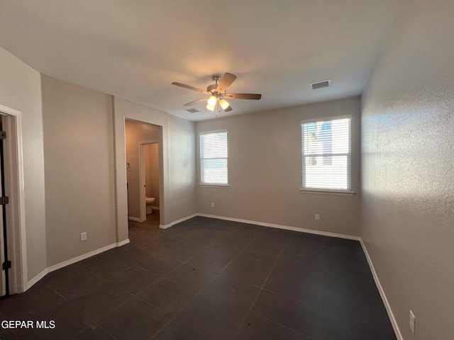 unfurnished room with a wealth of natural light and ceiling fan