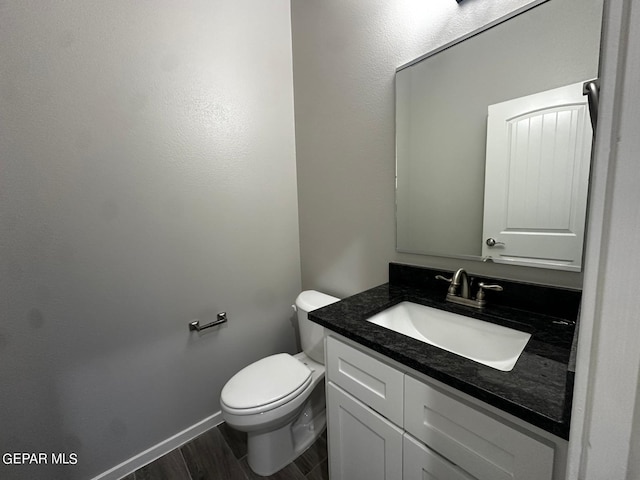 bathroom featuring vanity, toilet, and wood-type flooring