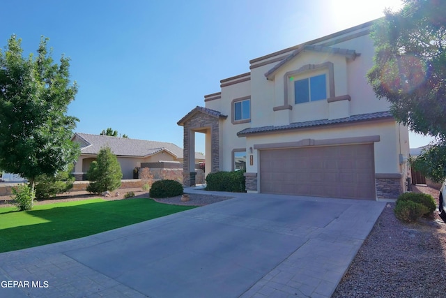 mediterranean / spanish house with a front lawn and a garage