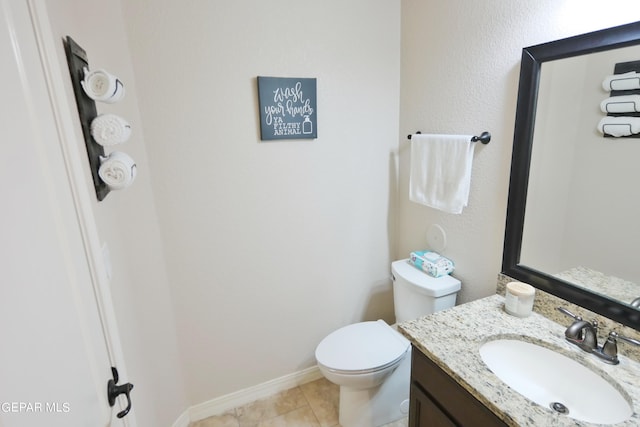 bathroom featuring tile patterned floors, vanity, and toilet