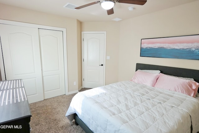 carpeted bedroom featuring ceiling fan and a closet