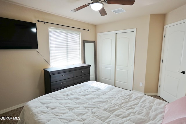 carpeted bedroom featuring a closet and ceiling fan