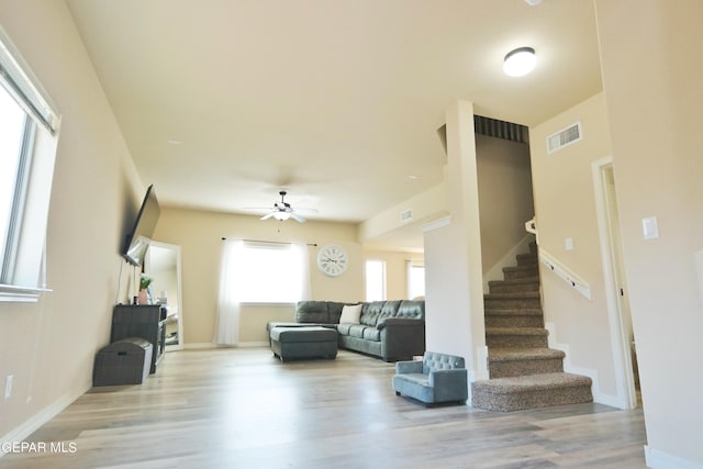 living room featuring ceiling fan and light hardwood / wood-style floors