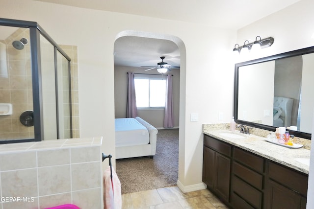 bathroom with ceiling fan, vanity, and an enclosed shower