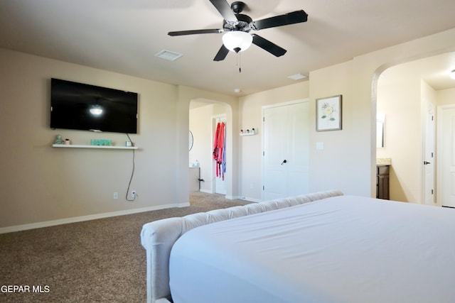 bedroom with carpet flooring, connected bathroom, a closet, and ceiling fan