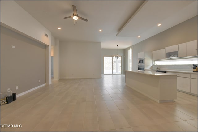 kitchen featuring white cabinets, a center island, stainless steel appliances, and pendant lighting