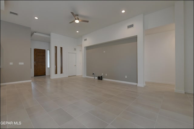 empty room with light tile patterned floors and ceiling fan