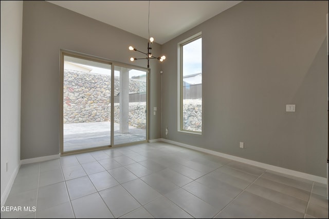 unfurnished dining area featuring light tile patterned flooring and a chandelier