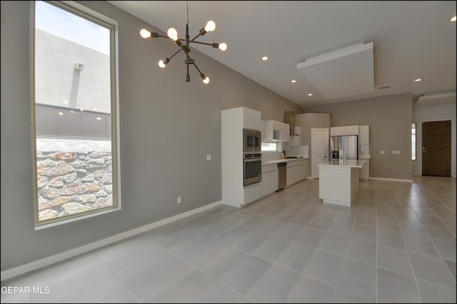 kitchen featuring white cabinetry, stainless steel appliances, a notable chandelier, decorative light fixtures, and light tile patterned flooring