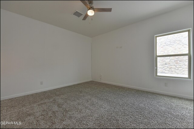 carpeted empty room featuring ceiling fan