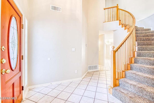 tiled foyer entrance with a high ceiling