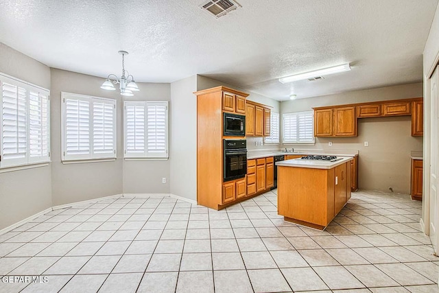 kitchen featuring decorative light fixtures, an inviting chandelier, light tile floors, black appliances, and a textured ceiling