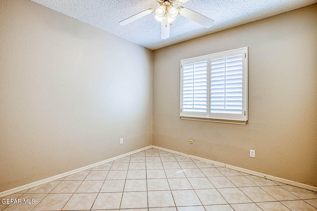 tiled spare room featuring ceiling fan and a textured ceiling