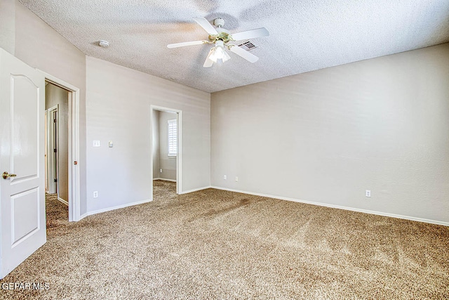 unfurnished bedroom featuring a textured ceiling, carpet floors, and ceiling fan