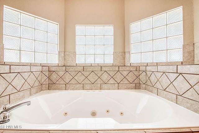 bathroom with tiled tub