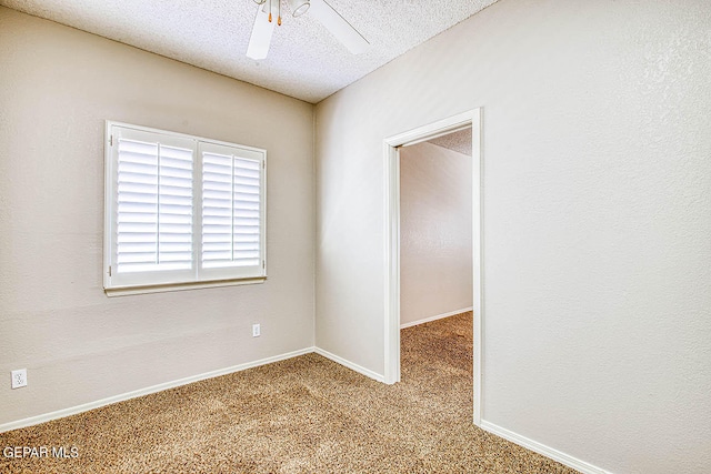 empty room featuring carpet, ceiling fan, and a textured ceiling