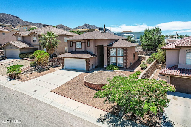 view of front of home featuring a garage and a mountain view