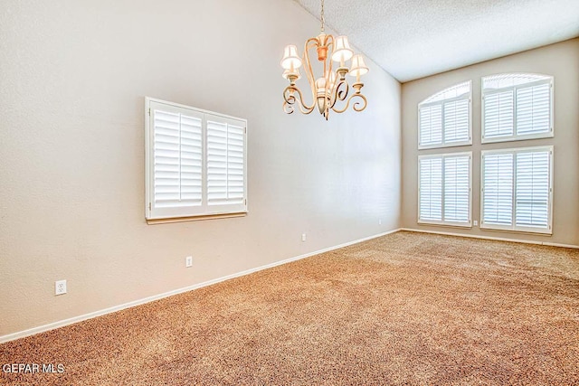 empty room with high vaulted ceiling, carpet, a chandelier, and a textured ceiling