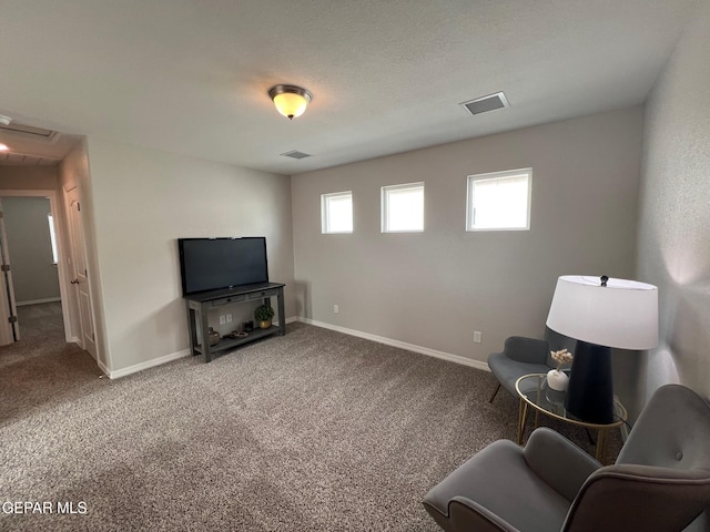 sitting room featuring baseboards, a textured ceiling, visible vents, and carpet flooring