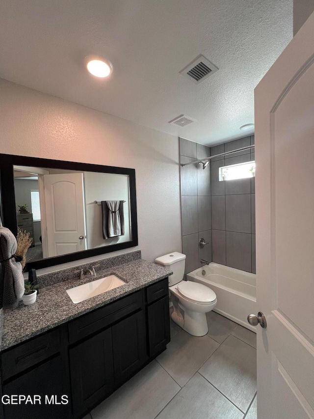 bathroom featuring visible vents, toilet,  shower combination, a textured ceiling, and vanity