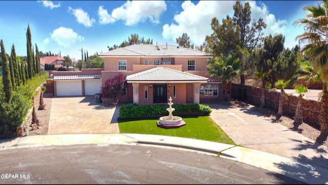 mediterranean / spanish home with a garage