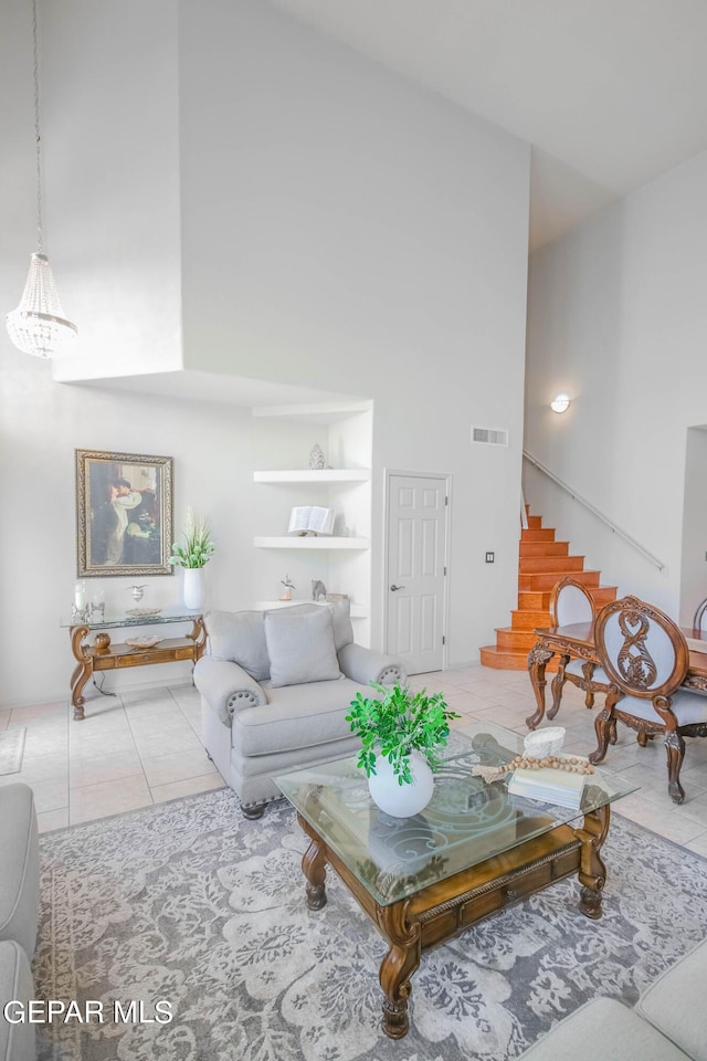 living room with tile patterned floors and a high ceiling