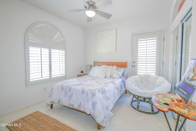 carpeted bedroom with multiple windows and ceiling fan