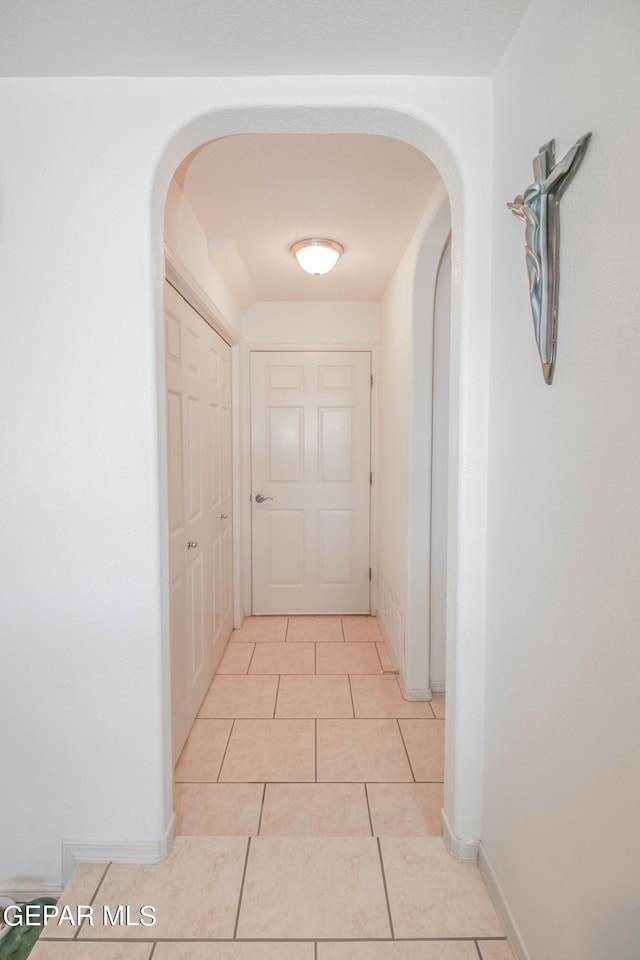 corridor featuring light tile patterned flooring