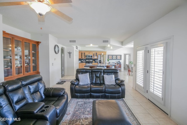 living room with ceiling fan and light tile patterned flooring