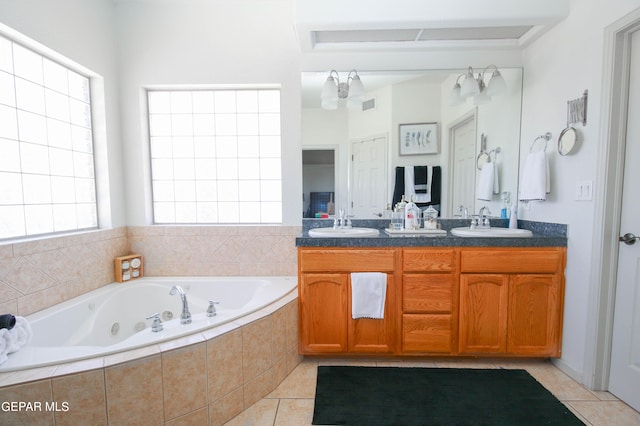 bathroom featuring vanity, tiled bath, and tile patterned floors