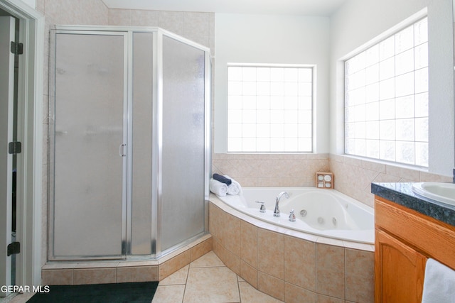 bathroom featuring tile patterned floors, a wealth of natural light, vanity, and independent shower and bath